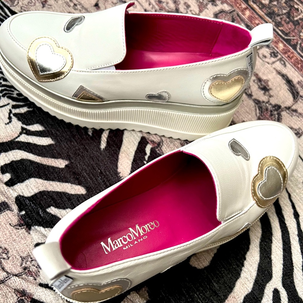Platform shoes in white with bold gold and silver stars.